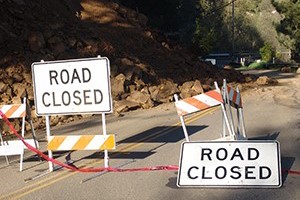 Road signs showing a road is closed due to a landslide